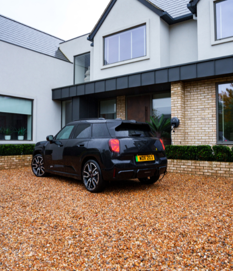electric mini next to pod point ev charger