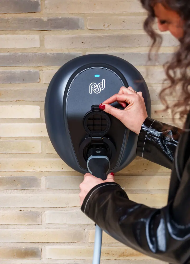Women plugging cable into untethered Pod Point ev charger