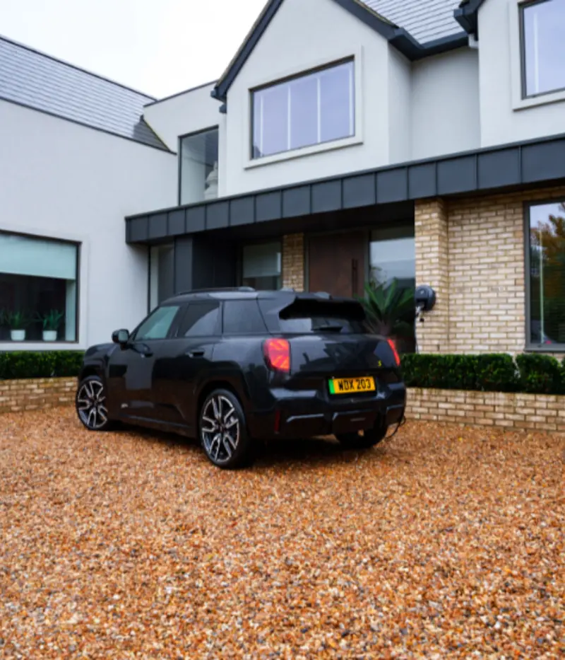 electric mini next to pod point ev charger