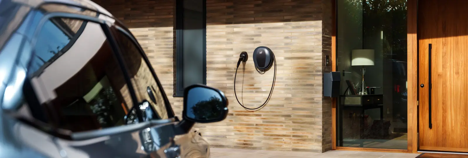pod point charger on wall next to front door of property