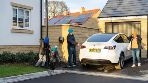 family charging EV in cold weather
