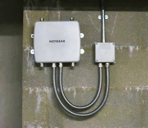 A close up of Devon Road's Wi-fi system installed on a large brick wall